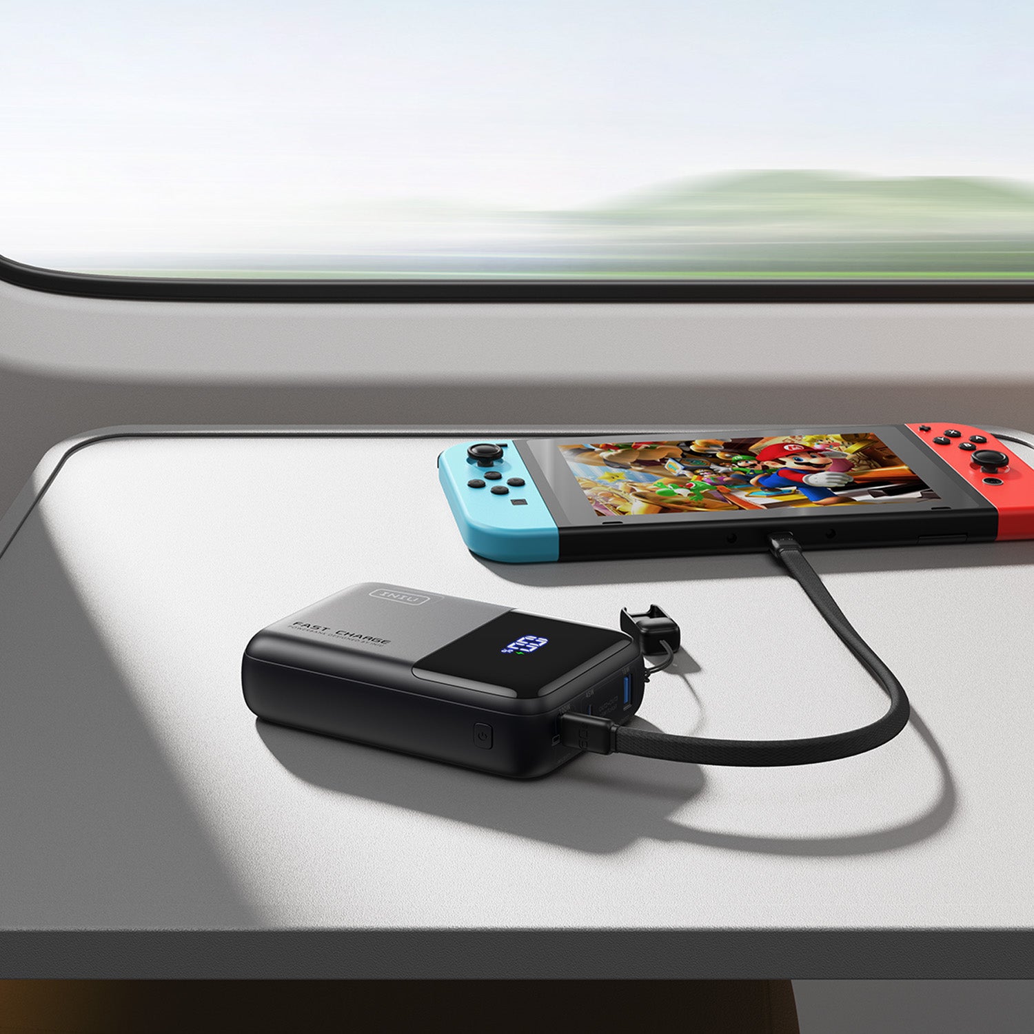 INIU Cougar P63-E1 Power Bank charging a Nintendo Switch, featuring 100W fast charge, ideal for travel and gaming.