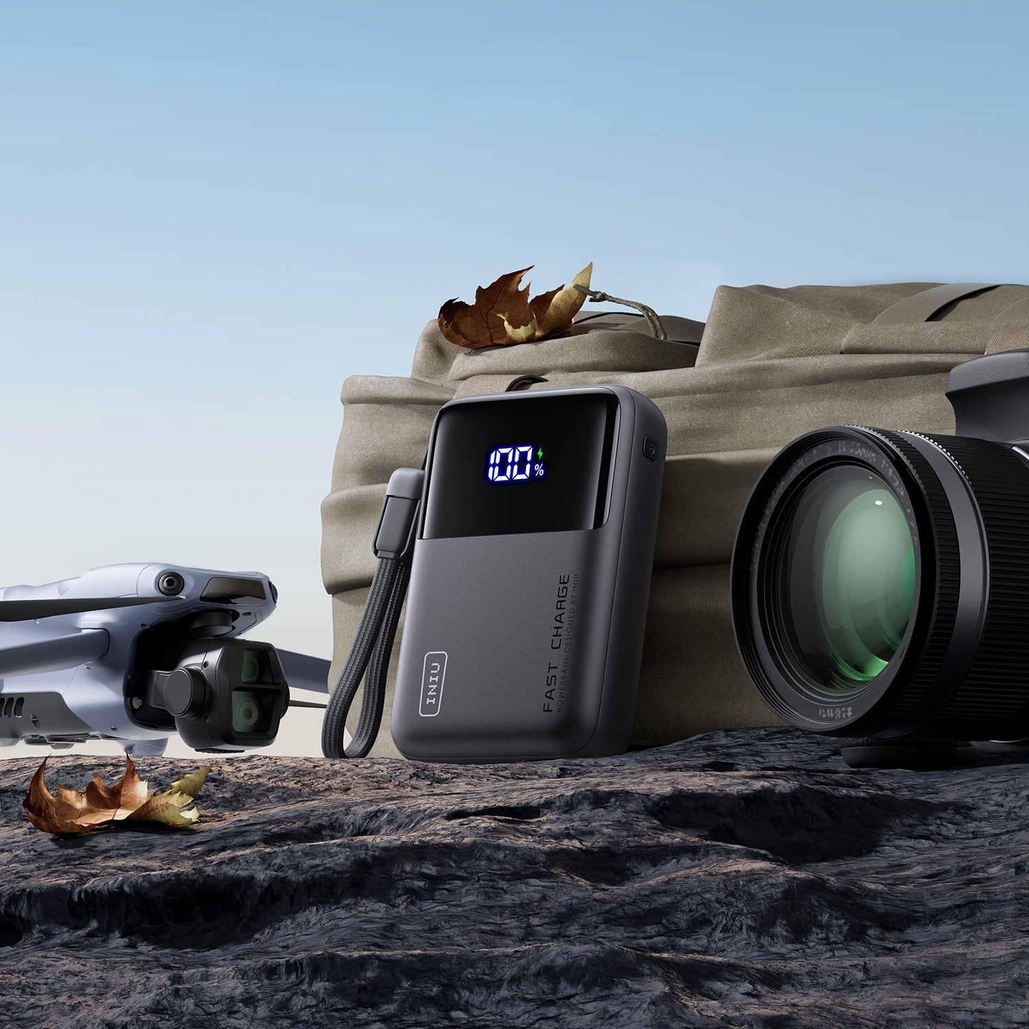 INIU Cougar P63-E1 Power Bank with 100% charge display, charging a drone and camera, features FAST CHARGE technology.