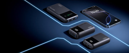 Three INIU portable power banks next to a smartphone.