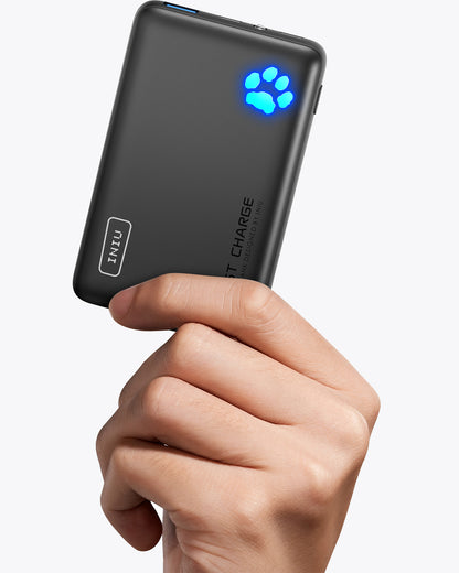 INIU P41-E1 Power Bank held in hand. Black portable charger with Fast Charge, paw indicator.