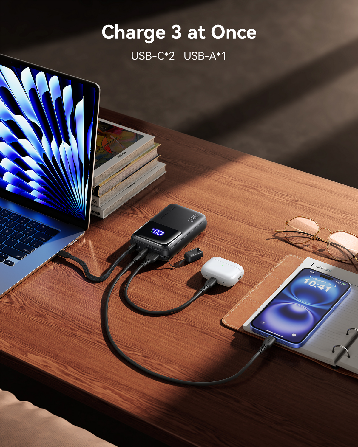 Black Friday deal: INIU power bank simultaneously charges laptop, AirPods, and smartphone, showcasing multi-device charging.